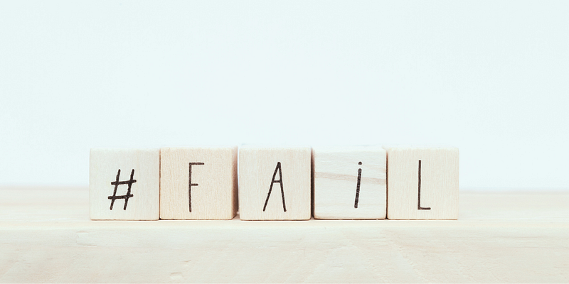 Wooden blocks with the letters "#FAIL"